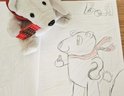 Drawing of a bear with the soft toy next to it
